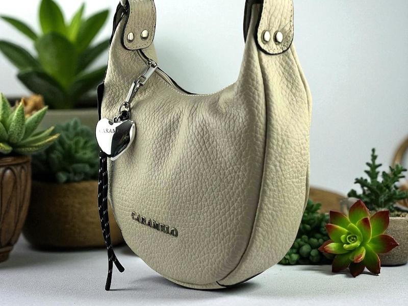  Bolso de mujer en piel legítima en color beige y letras metálicas en color plata. Bolso muy cómodo y versátil, ideal con todos los looks.