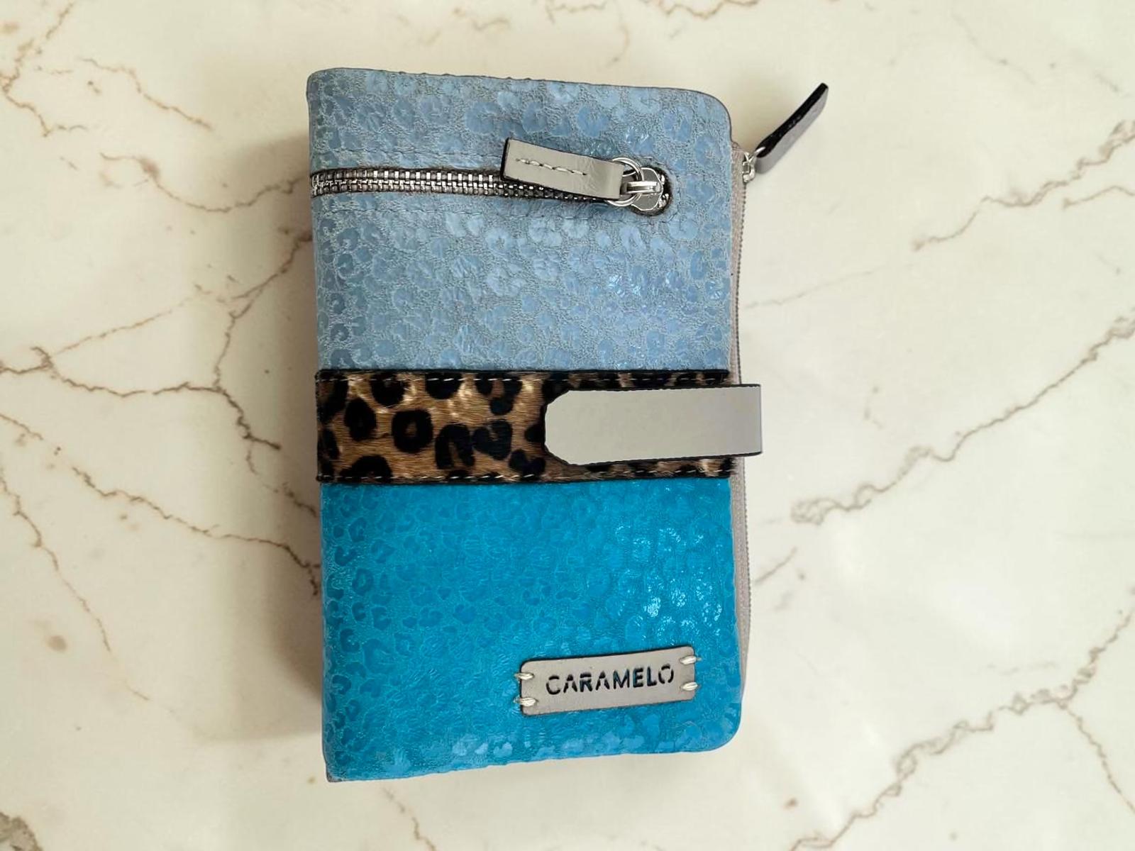 Billetera de piel para mujer marca Caramelo en tonos azules con franja central de leopardo y placa metálica.