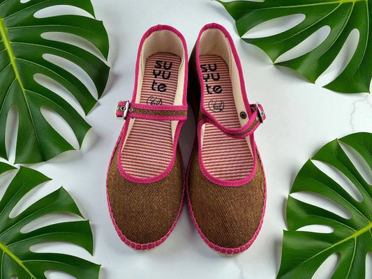 Merceditas artesanales, mujer, planas, de tela con patrón de espiga marrón, ribetes en fucsia,cierre de hebilla lateral y suela de yute natural.