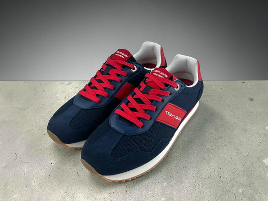 Zapatillas Teddy Smith 1989 de hombre color azul marino con franja roja lateral y logo bordado. Vista lateral completa sobre fondo blanco.